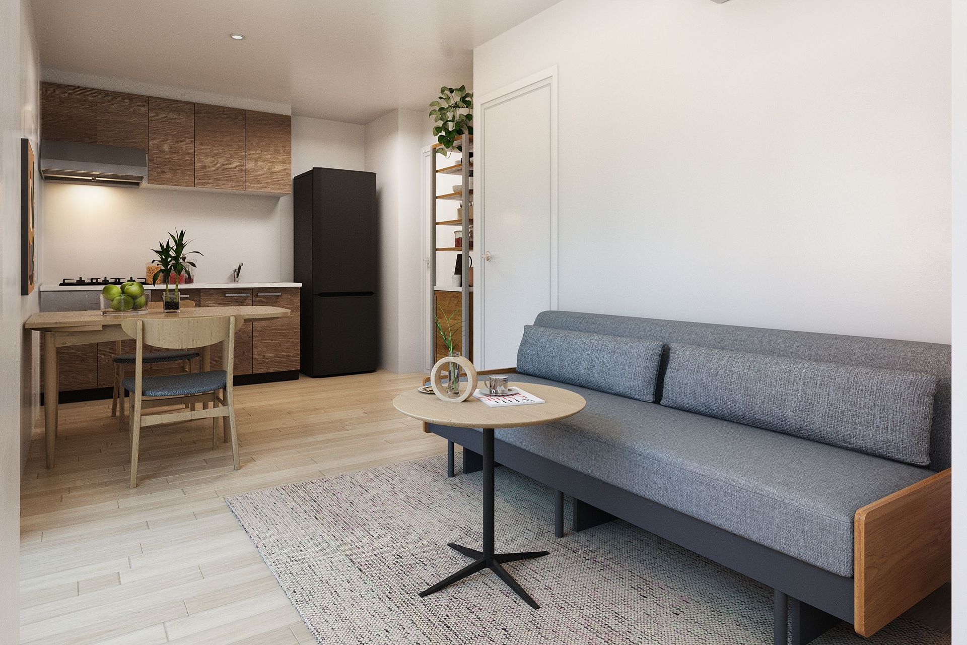 Modern studio apartment with a compact kitchen, dining area, and grey sofa.